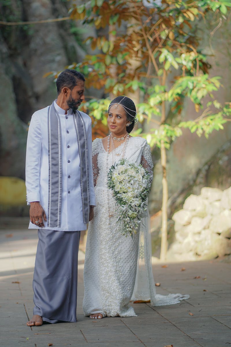 Sri Lankan couple in traditional attire walking hand in hand